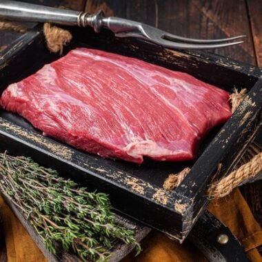 grass-fed-raw-flank-beef-meat-steak-wooden-tray-with-herbs-wooden-background-top-view_89816-39826